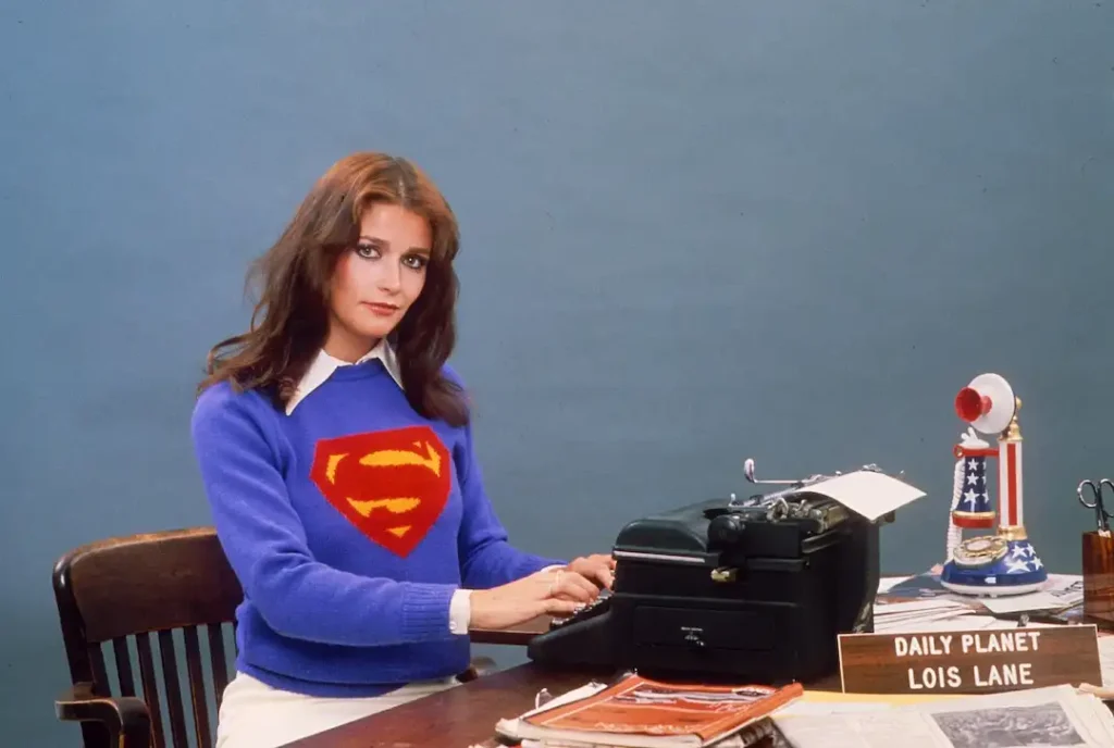 Margot Kidder wears a Superman jumper